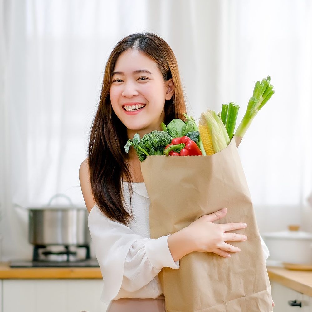 Happy shopper with fresh groceries